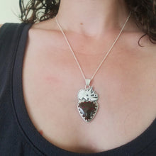 a woman wearing silver triceratops skull dinosaur bone necklace