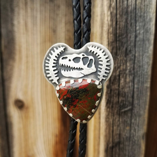 silver t-rex skull dinosaur bone bolo tie on a leather cord