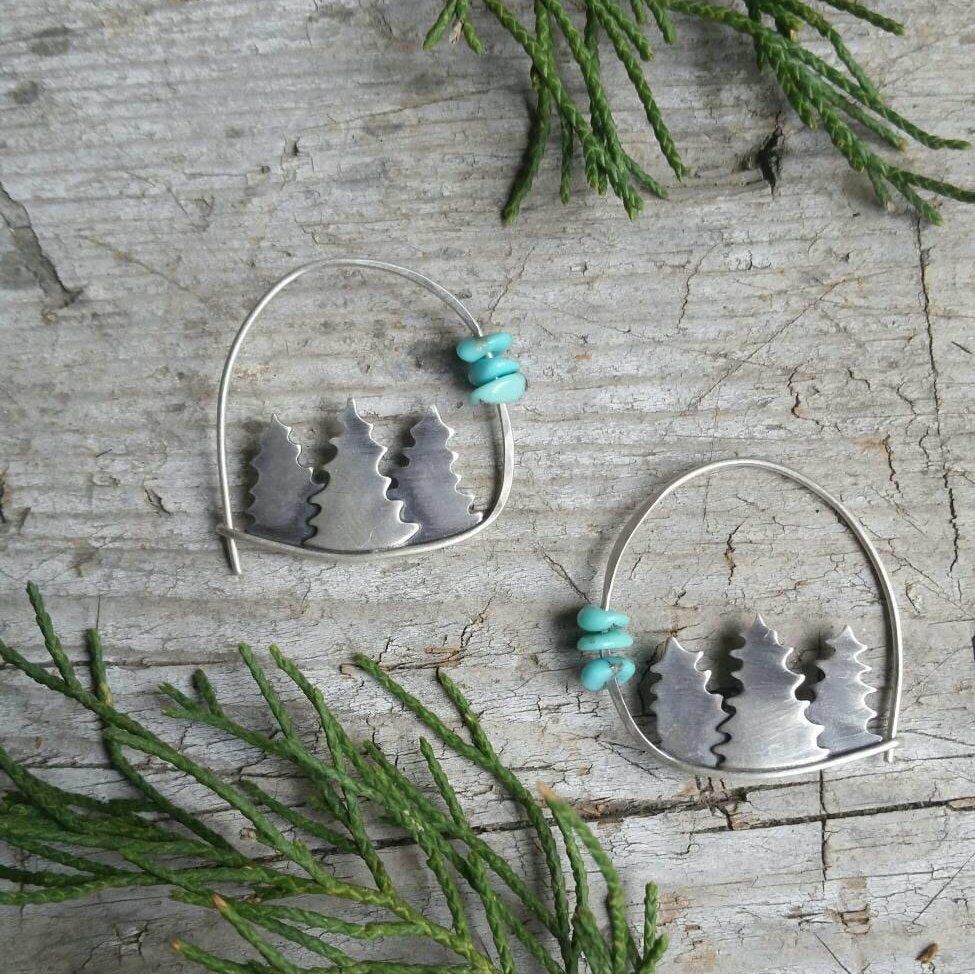 silver forest hoop earrings with turquoise beads framed by juniper sprigs